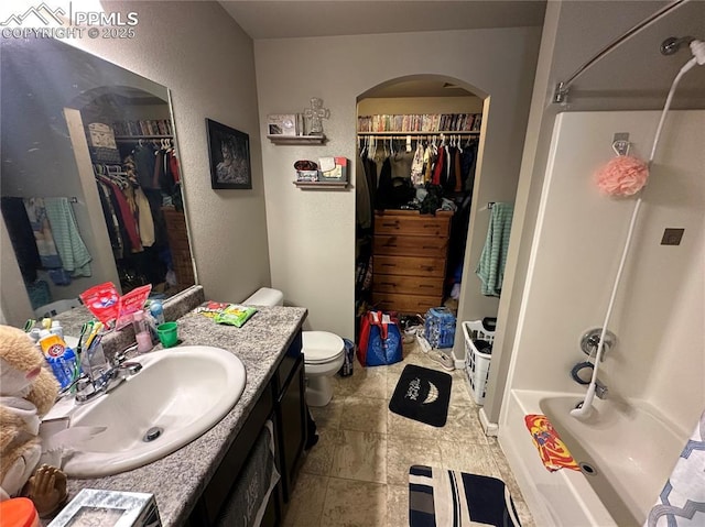 full bathroom featuring bathing tub / shower combination, toilet, and vanity