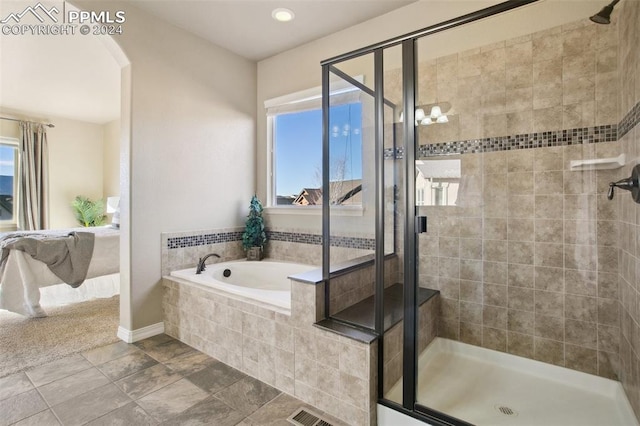 bathroom featuring shower with separate bathtub and a healthy amount of sunlight