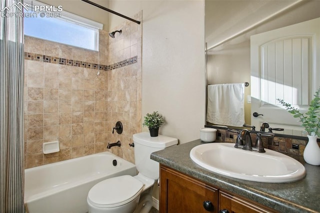 full bathroom with vanity, tiled shower / bath combo, and toilet