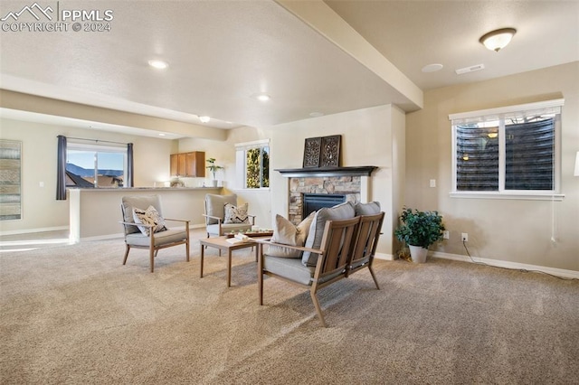 living room featuring a fireplace and light carpet