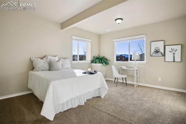 carpeted bedroom featuring beam ceiling