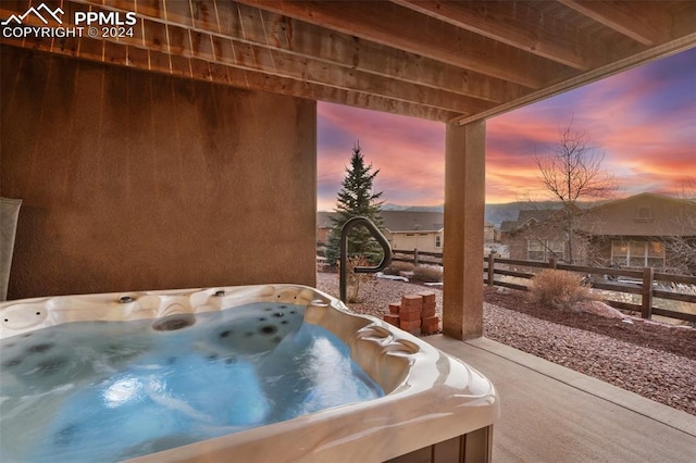 patio terrace at dusk with a hot tub