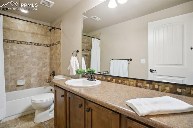 full bathroom with shower / bath combo, vanity, and toilet