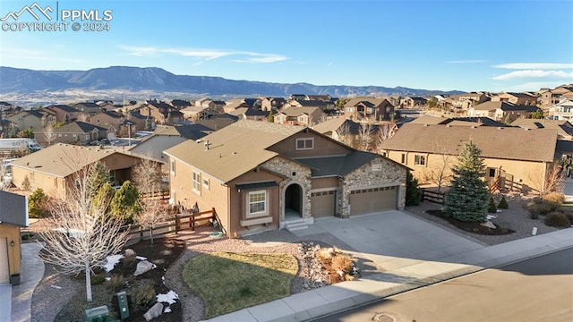 view of front of property with a mountain view and a garage