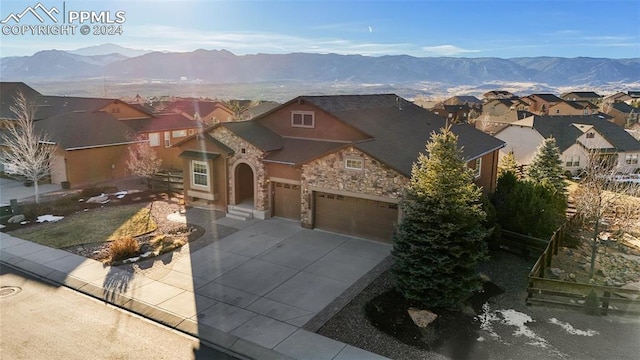 view of front of home with a mountain view and a garage