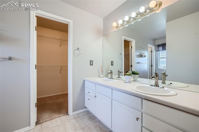 bathroom featuring tile patterned flooring and vanity