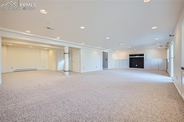 unfurnished living room with light colored carpet and baseboard heating