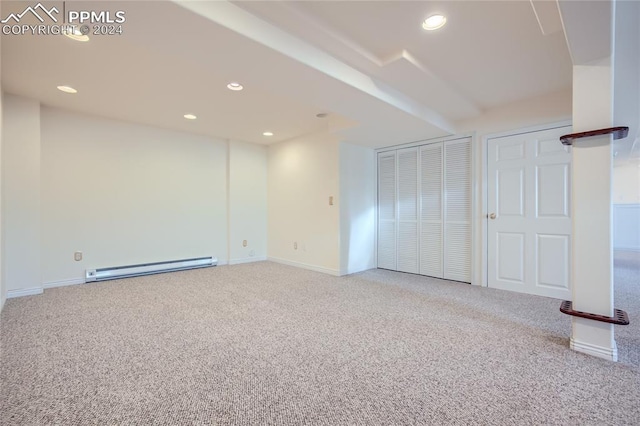 carpeted spare room featuring a baseboard radiator