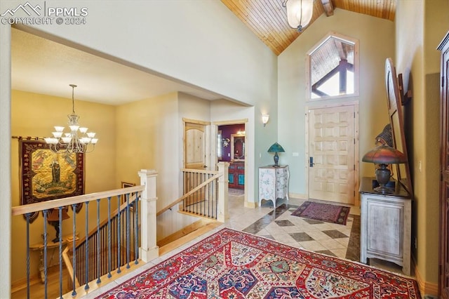 entrance foyer featuring lofted ceiling with beams, light tile patterned flooring, wooden ceiling, and an inviting chandelier