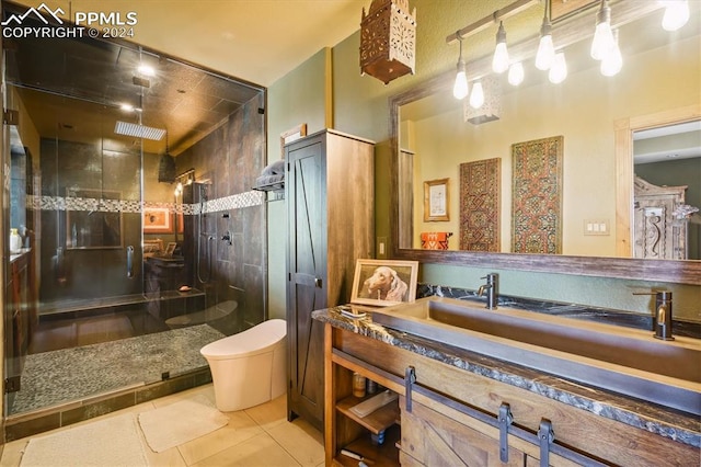 bathroom featuring tile patterned floors, a shower with door, vanity, and toilet