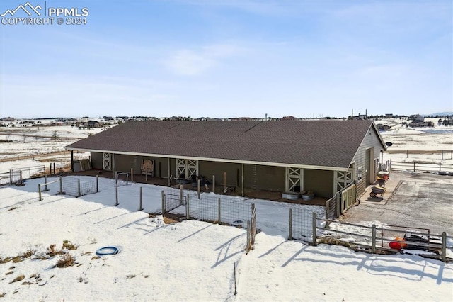 snow covered house featuring an outdoor structure