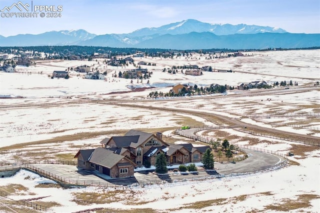 snowy aerial view featuring a mountain view