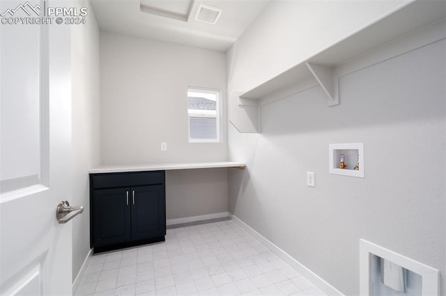 laundry room featuring washer hookup and cabinets