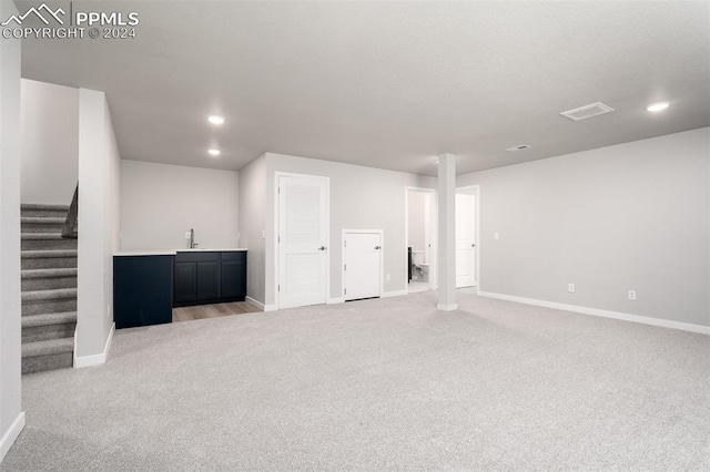 interior space featuring light carpet and wet bar