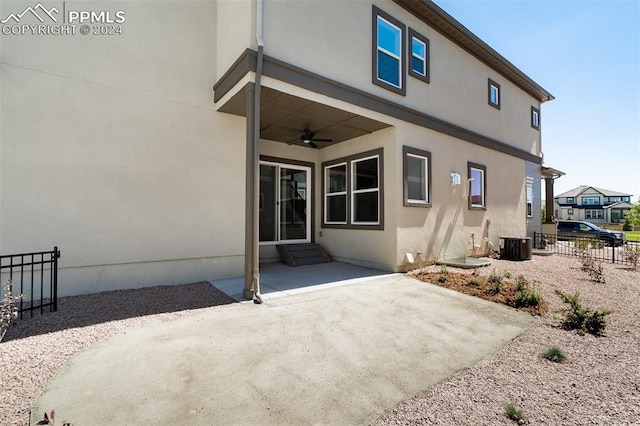 back of house with central AC unit, ceiling fan, and a patio area