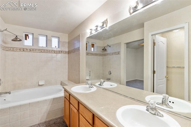 bathroom with vanity and tiled shower / bath combo