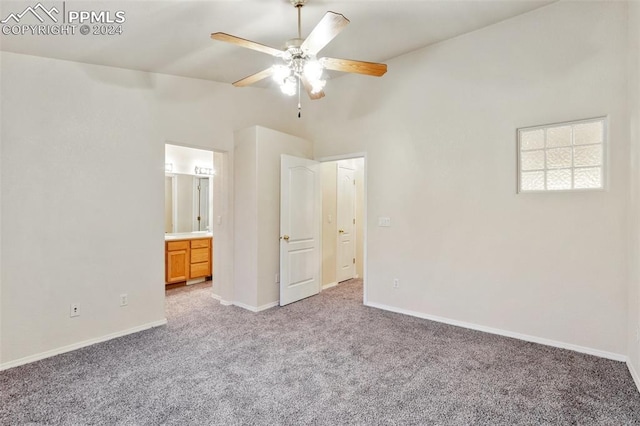 unfurnished bedroom featuring ceiling fan, ensuite bathroom, and light carpet