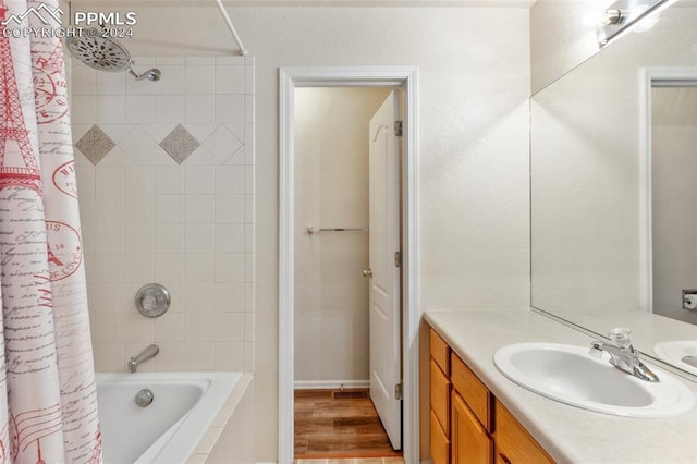 bathroom featuring shower / bath combination with curtain, vanity, and wood-type flooring