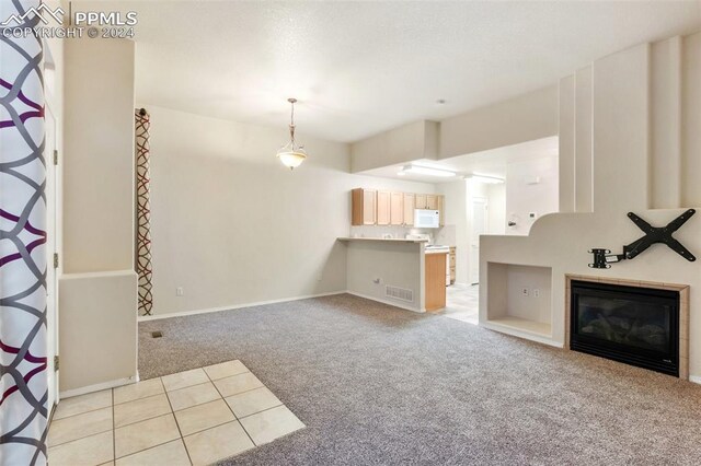 unfurnished living room with light colored carpet