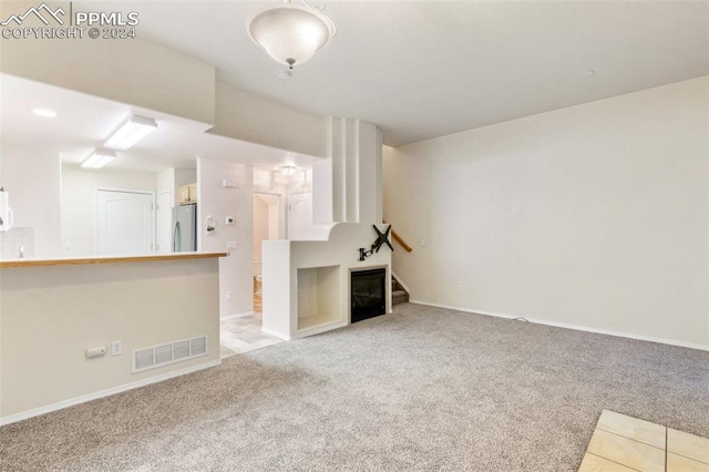 unfurnished living room with carpet