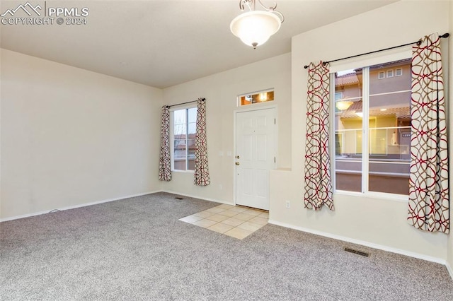 entrance foyer featuring light carpet