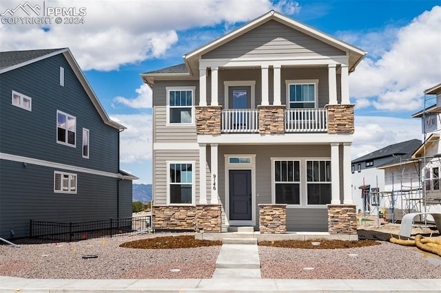 view of front of home featuring a balcony