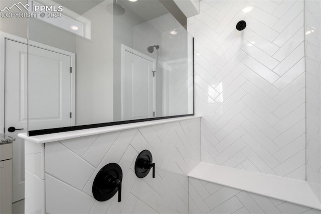 bathroom featuring vanity and a tile shower