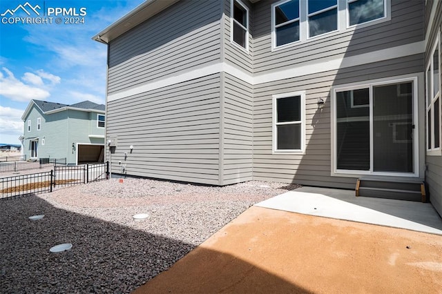 view of side of property with a patio area