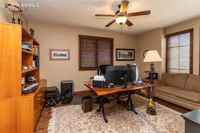 office area with light hardwood / wood-style flooring and ceiling fan