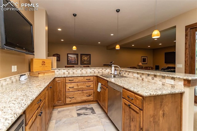 kitchen featuring kitchen peninsula, light stone counters, sink, pendant lighting, and dishwasher