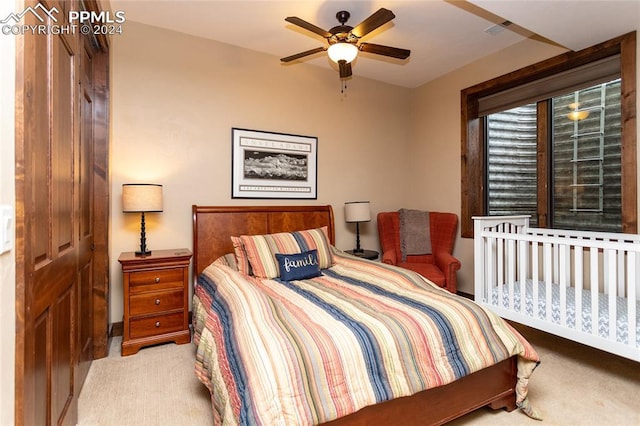 carpeted bedroom featuring ceiling fan and a closet