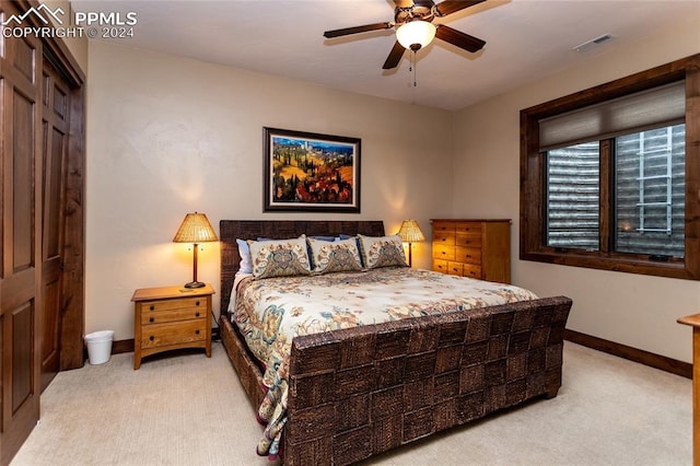 carpeted bedroom featuring a closet and ceiling fan