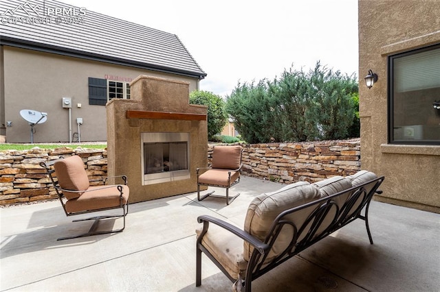 view of patio featuring exterior fireplace