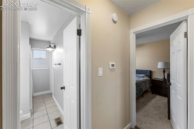 hall featuring light tile patterned floors