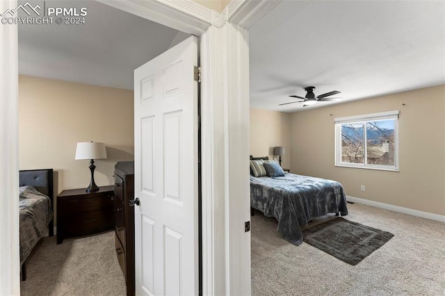 bedroom with light carpet and ceiling fan