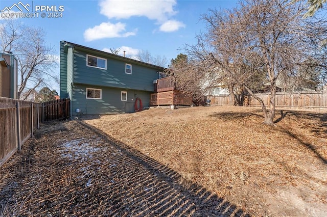 back of house with a wooden deck