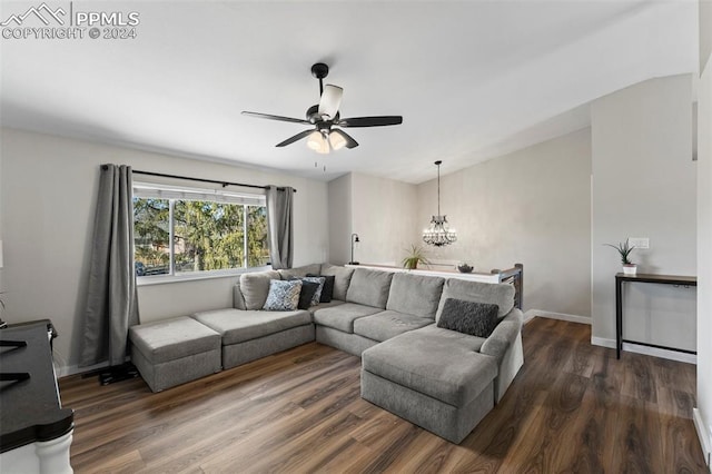 living room with ceiling fan with notable chandelier and dark wood-type flooring