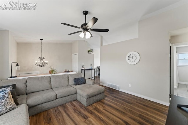 living room with hardwood / wood-style floors and ceiling fan with notable chandelier