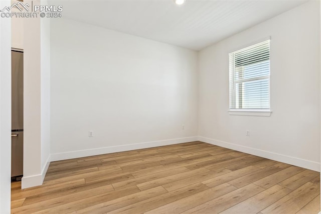 empty room with light hardwood / wood-style flooring