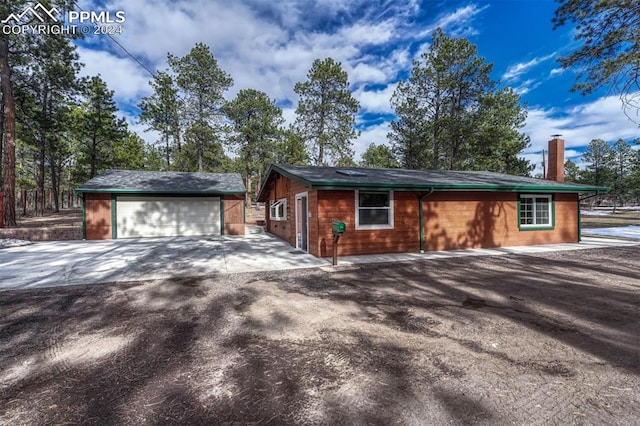 view of side of property with a garage and an outdoor structure