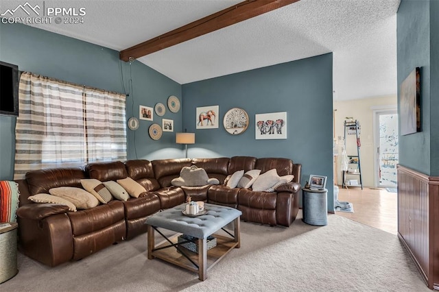 carpeted living room with lofted ceiling with beams and a textured ceiling