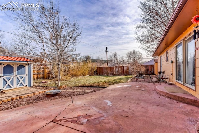 view of patio with a storage shed