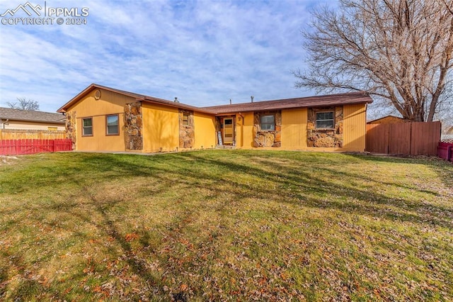 rear view of property with a lawn