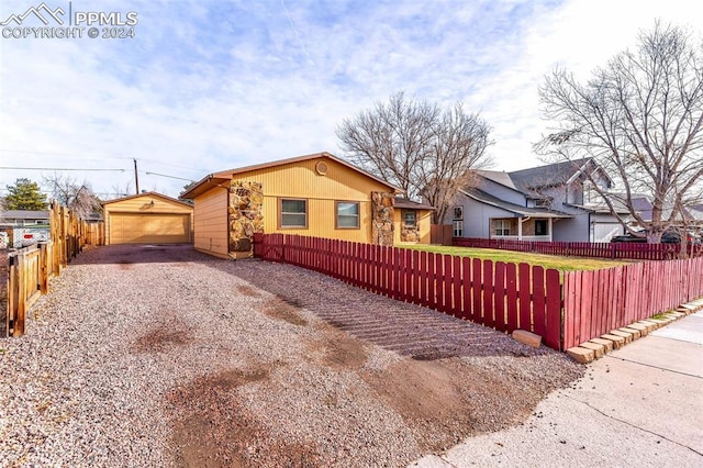 view of side of property with a garage and an outdoor structure