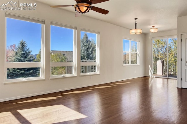 spare room with ceiling fan and dark hardwood / wood-style floors