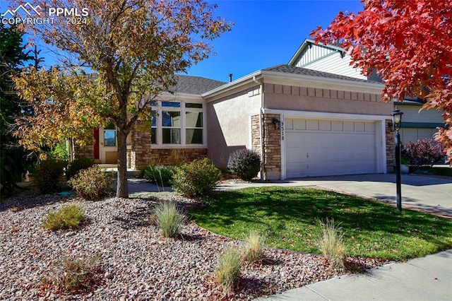 view of front facade with a front yard and a garage