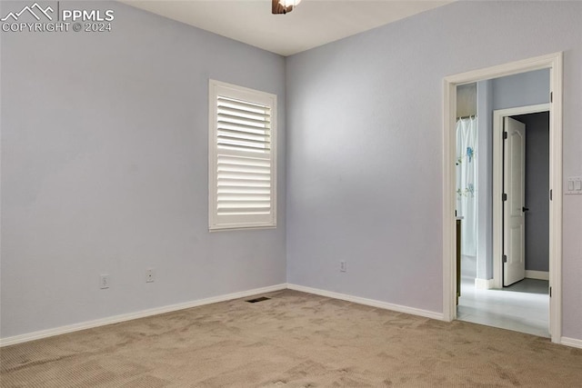 unfurnished room with light colored carpet