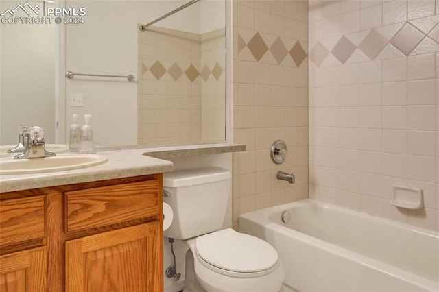 full bathroom with vanity, toilet, and tiled shower / bath combo