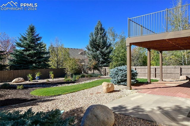 view of yard with a patio and a wooden deck