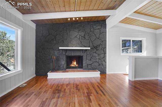 unfurnished living room with hardwood / wood-style floors, a fireplace, and plenty of natural light